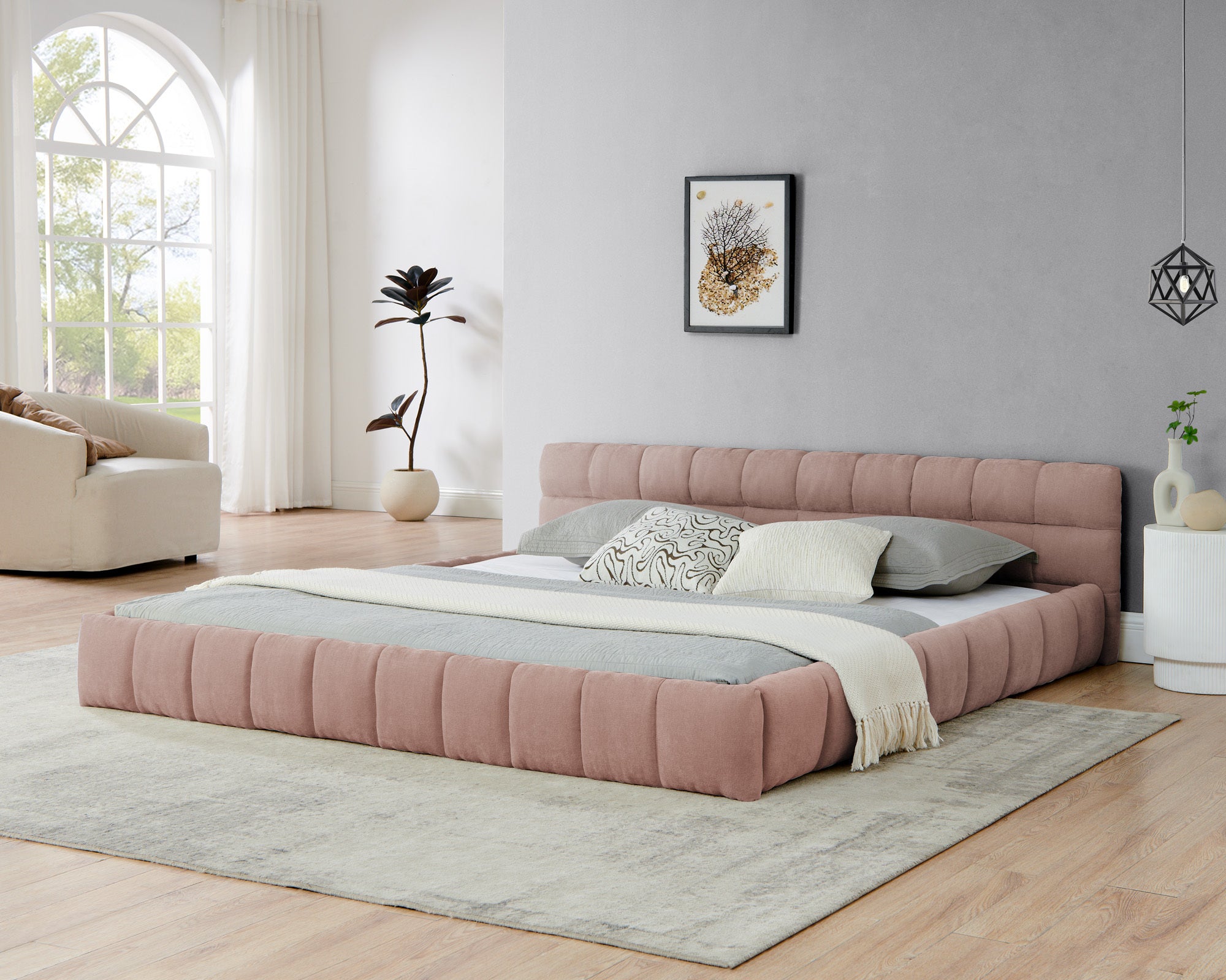 Pink upholstered king bed frame, front angle view in a modern bedroom setting