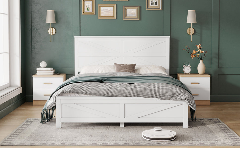 Straight-on view of the white barn door queen bed between two lamp-topped nightstands under gallery frames