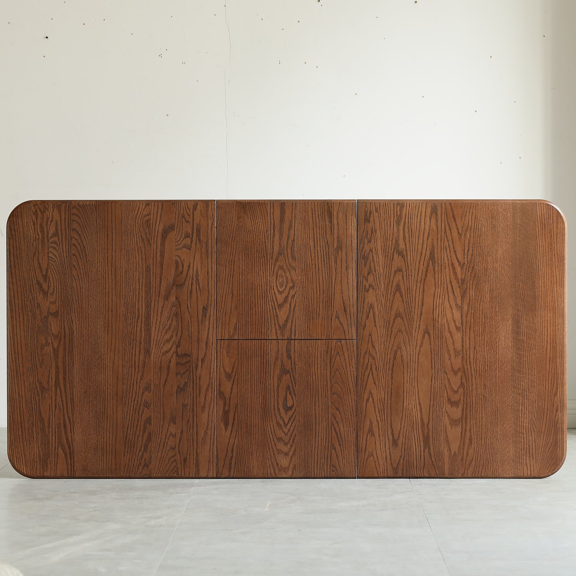 Overhead view of the walnut oak tabletop showing the grain and center leaf seam