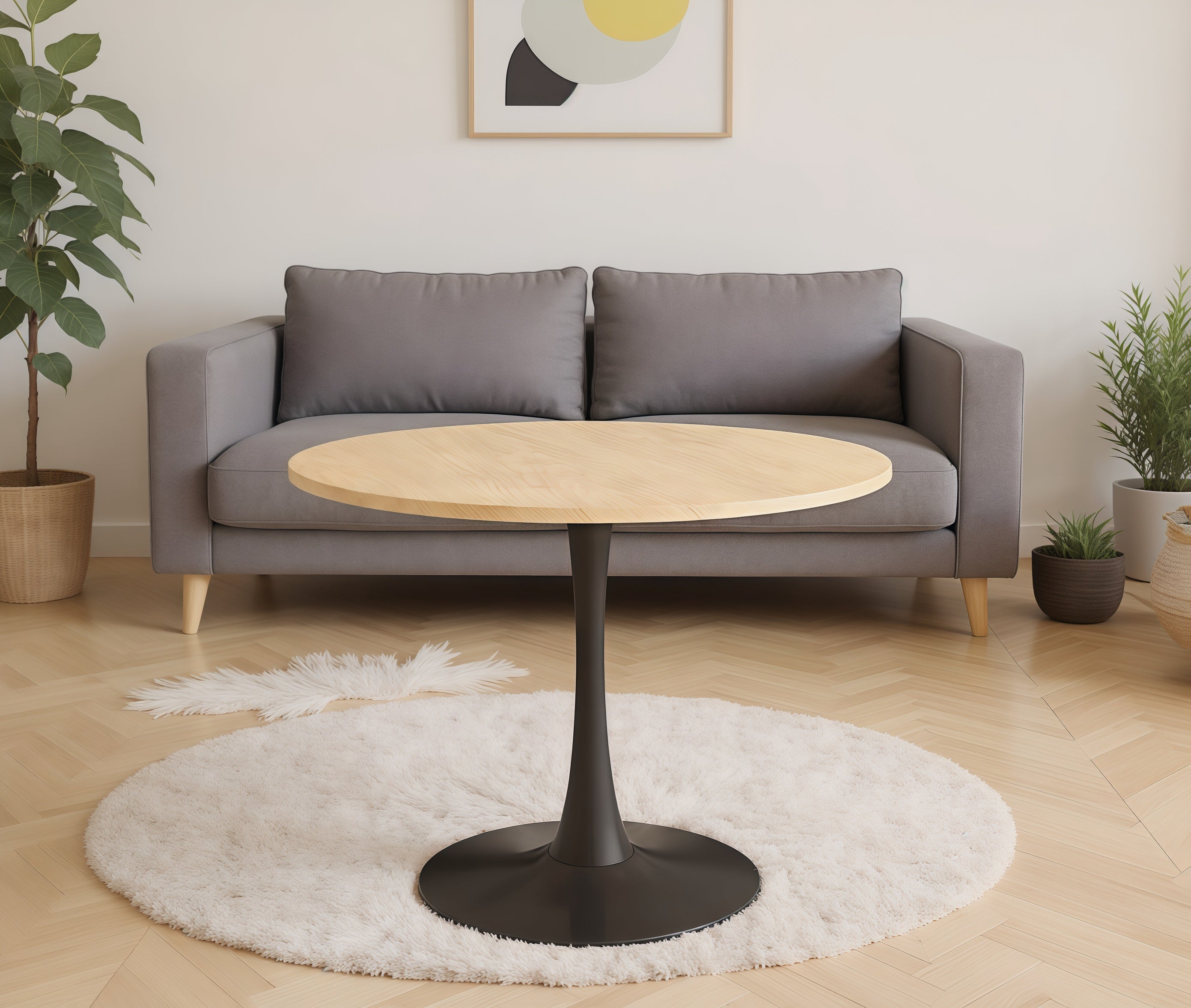 Natural wood round bistro table on a white rug in front of a gray sofa in a styled living room