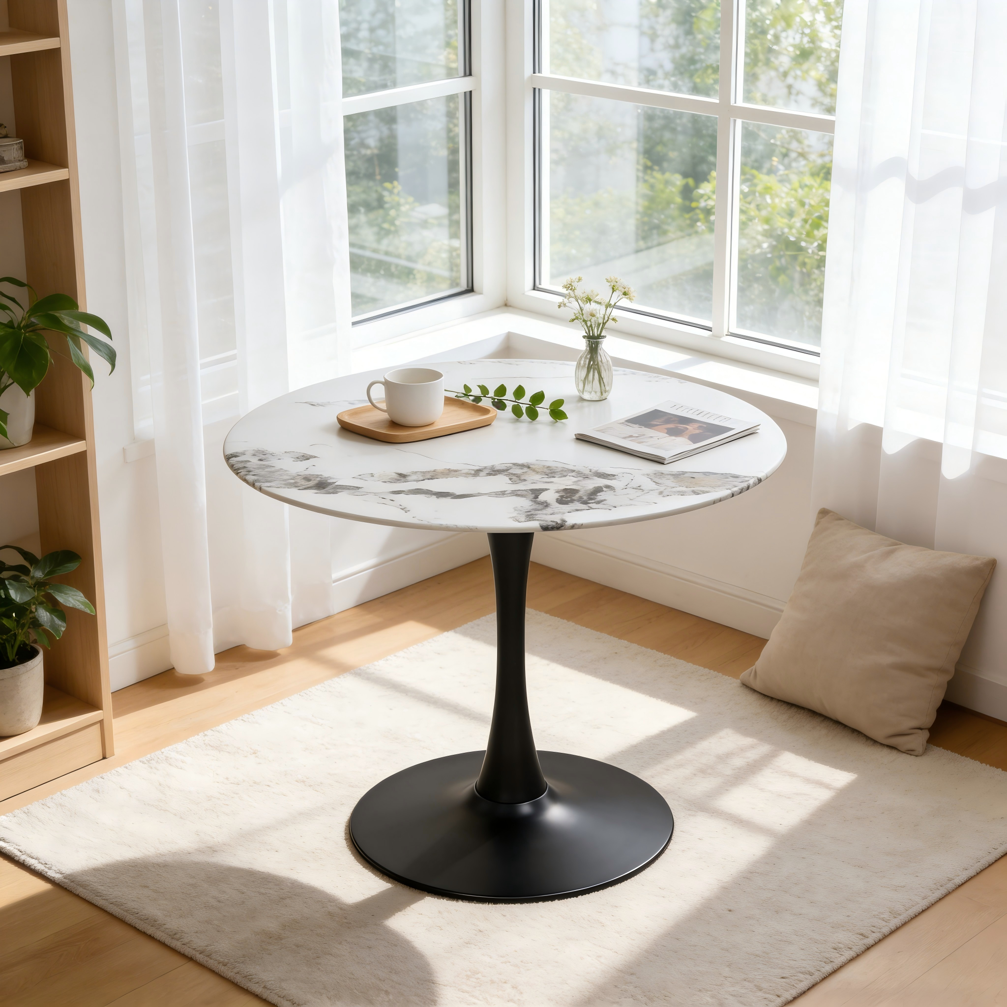 Overhead angle of the faux marble tulip table with black base in a bright window nook