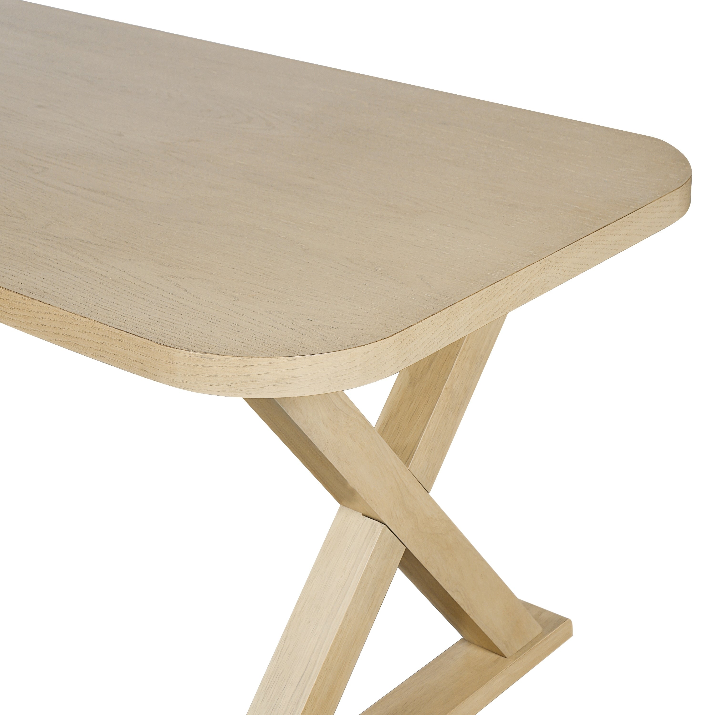 Close-up of a rounded tabletop corner meeting the oak X-leg, plain white background