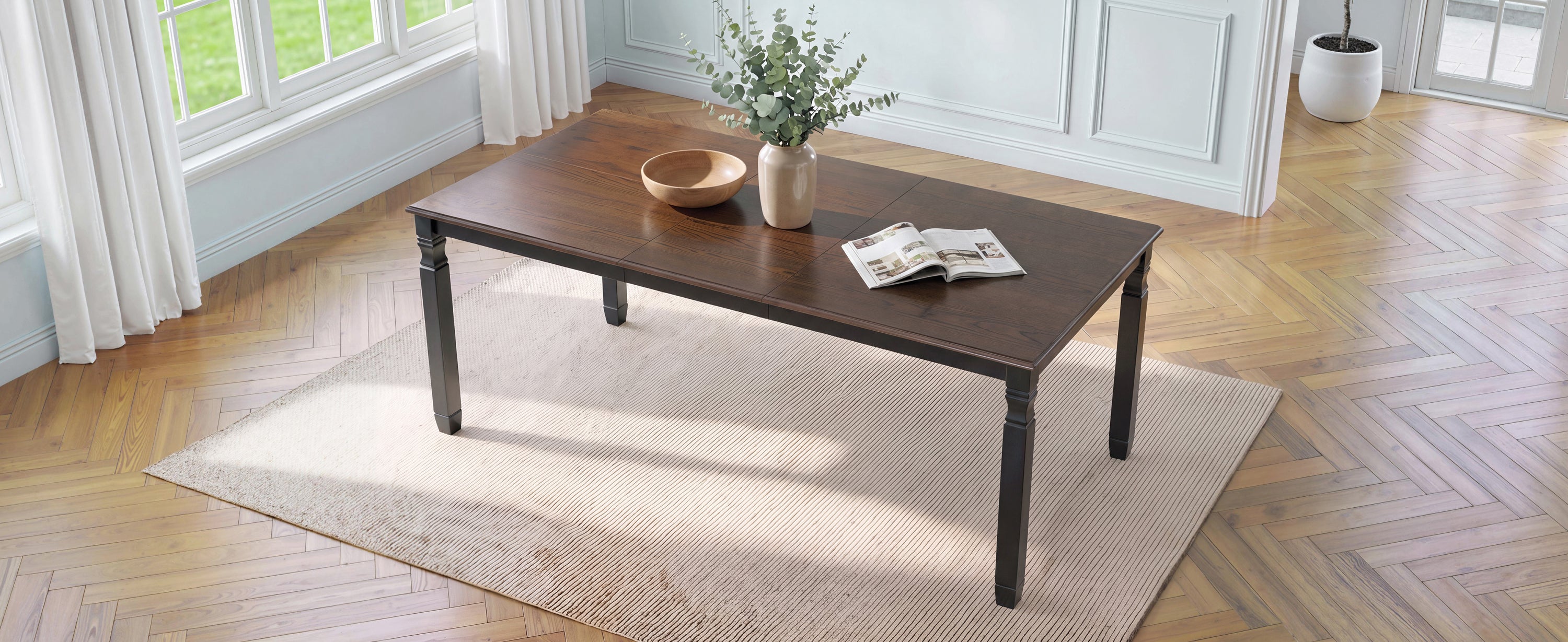 Espresso oak veneer farmhouse dining table, wide three-quarter overhead view in a bright styled room