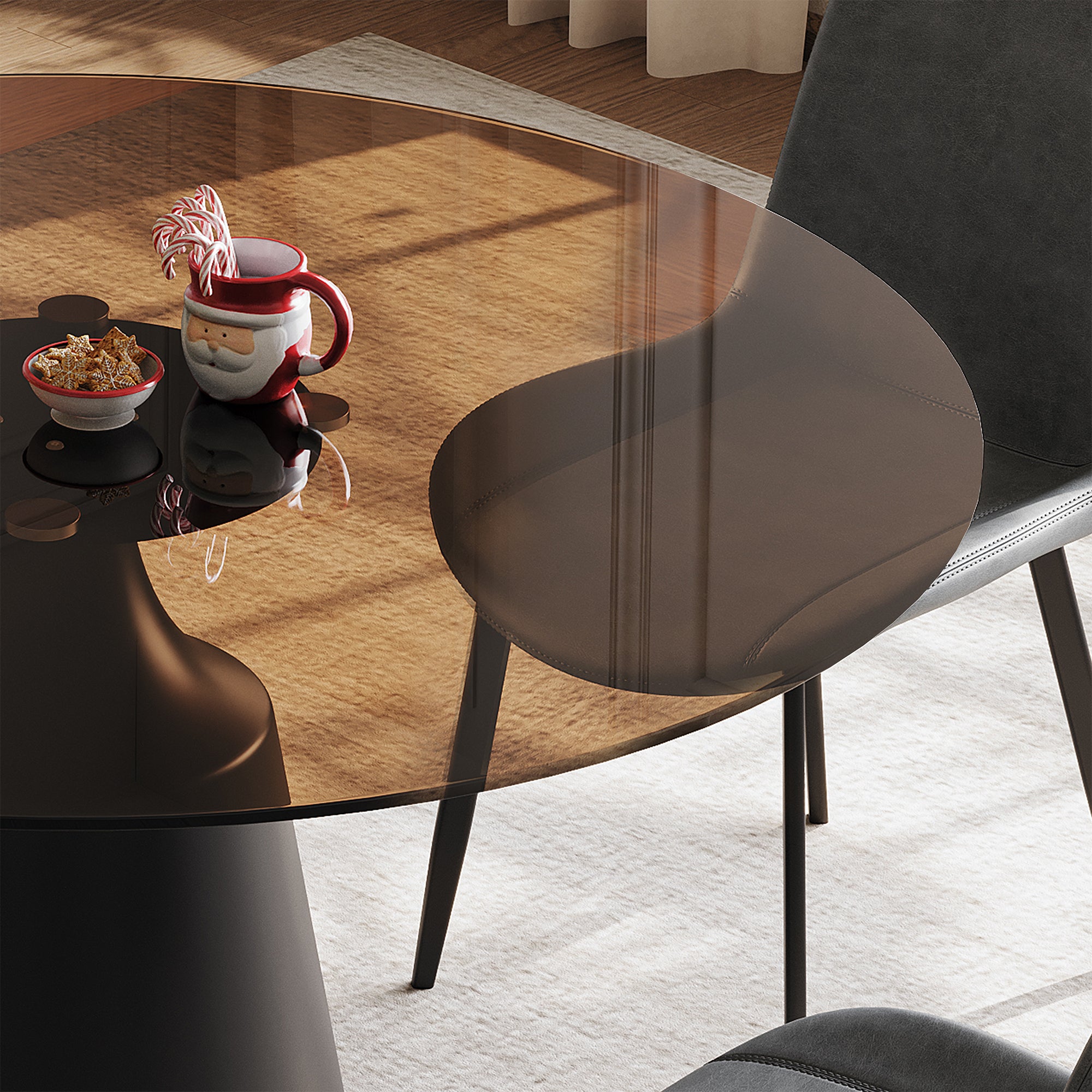 Overhead close-up of the brown glass tabletop beside a gray upholstered chair