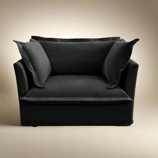 studio shot of the fluffy chair in black chenille showing the plush cushions and deep wide seat