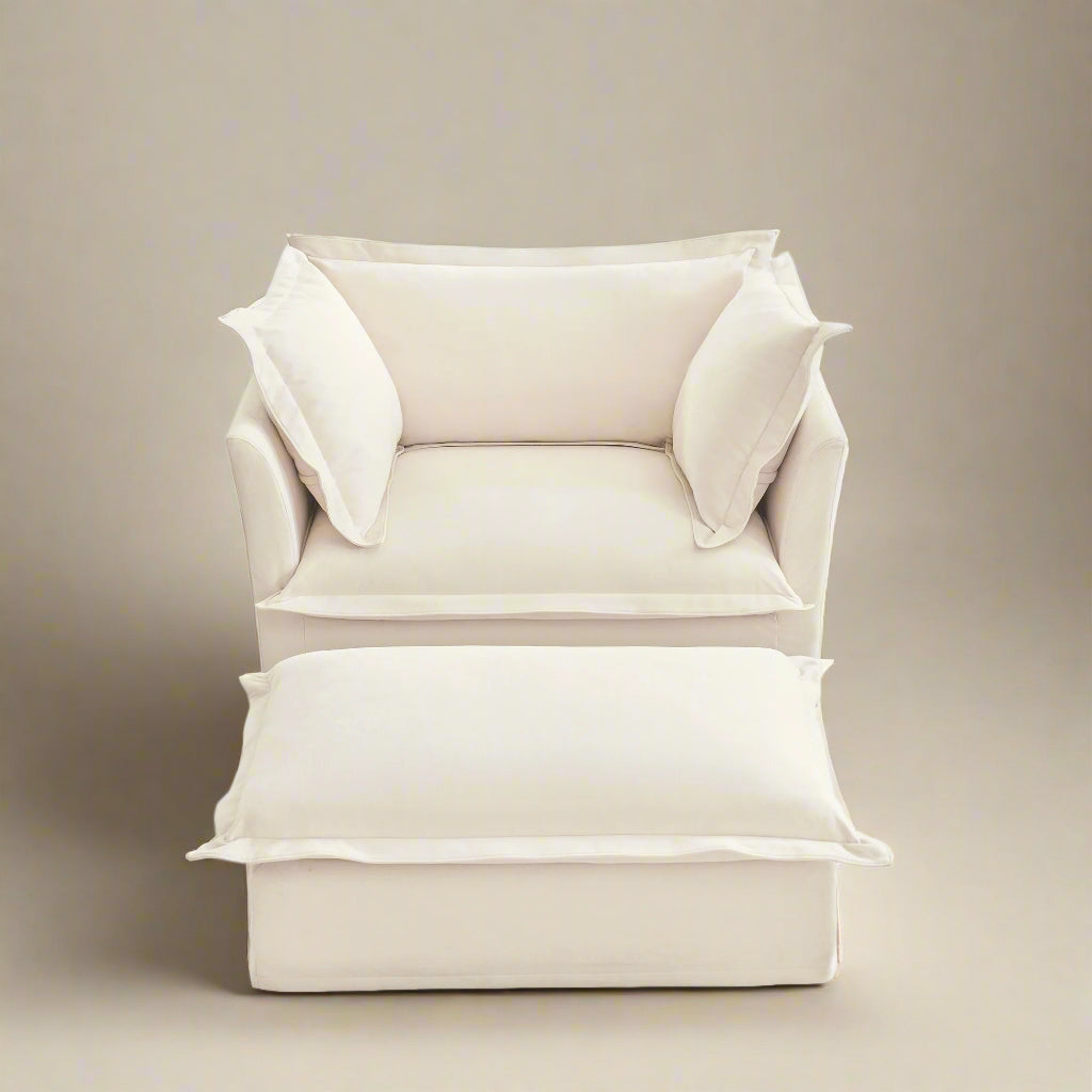 studio shot of the big fluffy chair in chenille cream with ottoman showing the plush rich texture of the chenille upholstery the wide deep seat and plush cushions.