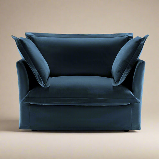 studio shot of the fluffy chair in navy chenille showcasing the plush upholstery pillows and wide seat and back with removable slip covers making it washable