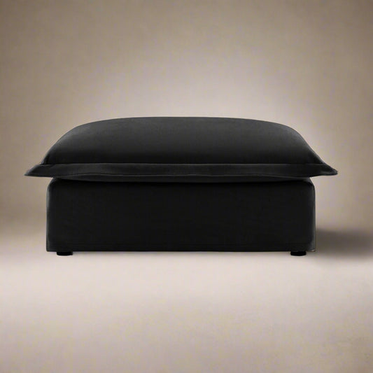 closeup shot of the fluffy ottoman in black chenille showing the rich color, plush seat and luxurious upholstery