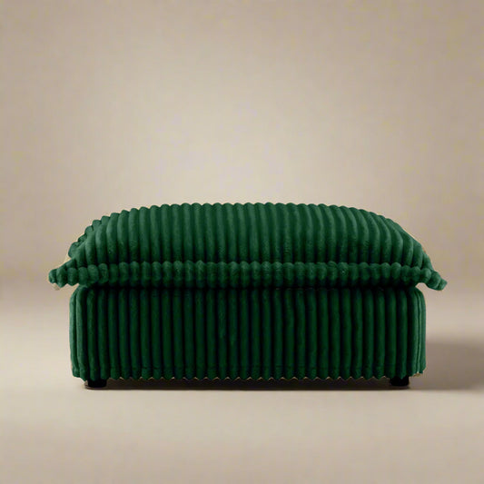 closeup of the fluffy ottoman in emerald corduroy showing the ridged comfort of the corduory upholstery rich color and plush seat