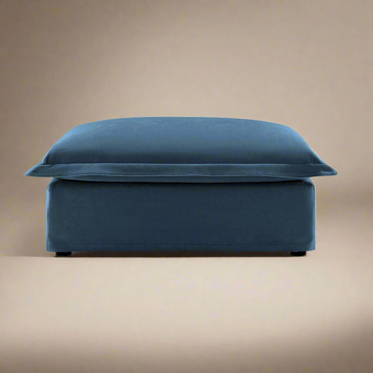 studio photo of the fluffy ottoman in navy chenille showing the beautiful rich navy colored upholstery and comfortable seat cushion