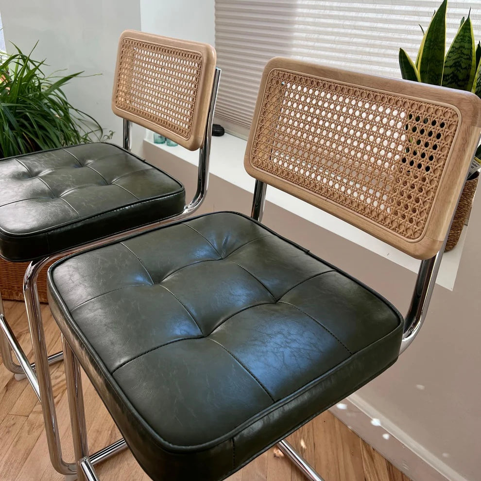 side view of counter height bar stools for 36 inch counter with green vegan leather seats and solid wood rattan back rests