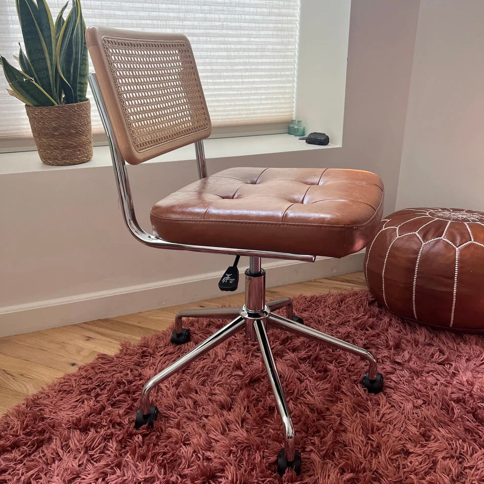 mid century modern armless desk chair with brown vegan leather seat and stainless steel frame