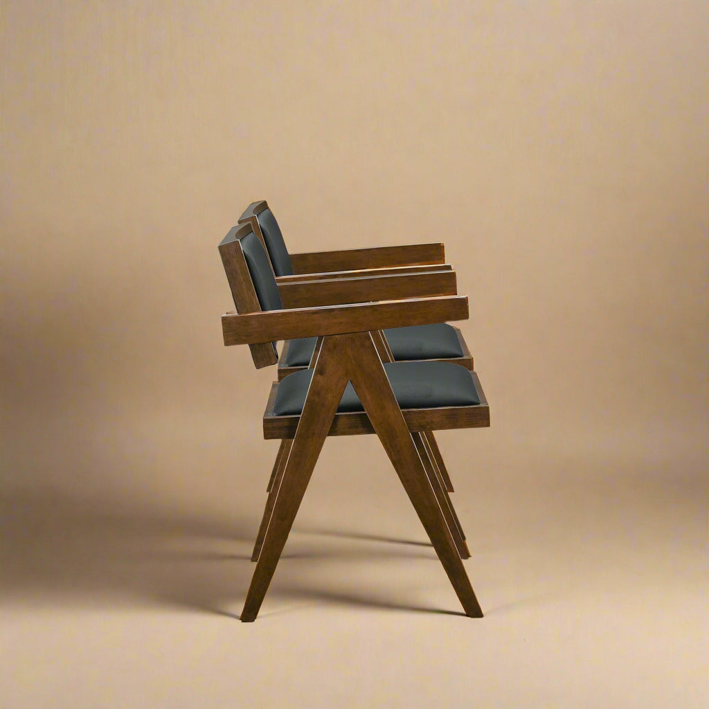 side view of mid century modern solid wood vegan leather dining chairs showing shadows and pattern on the wood
