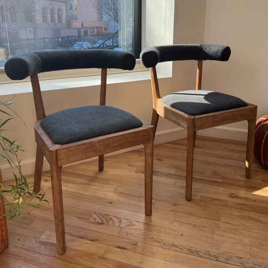 solid wood dining chairs with navy upholstery and ergonomic backrests suitable for a circular dining table