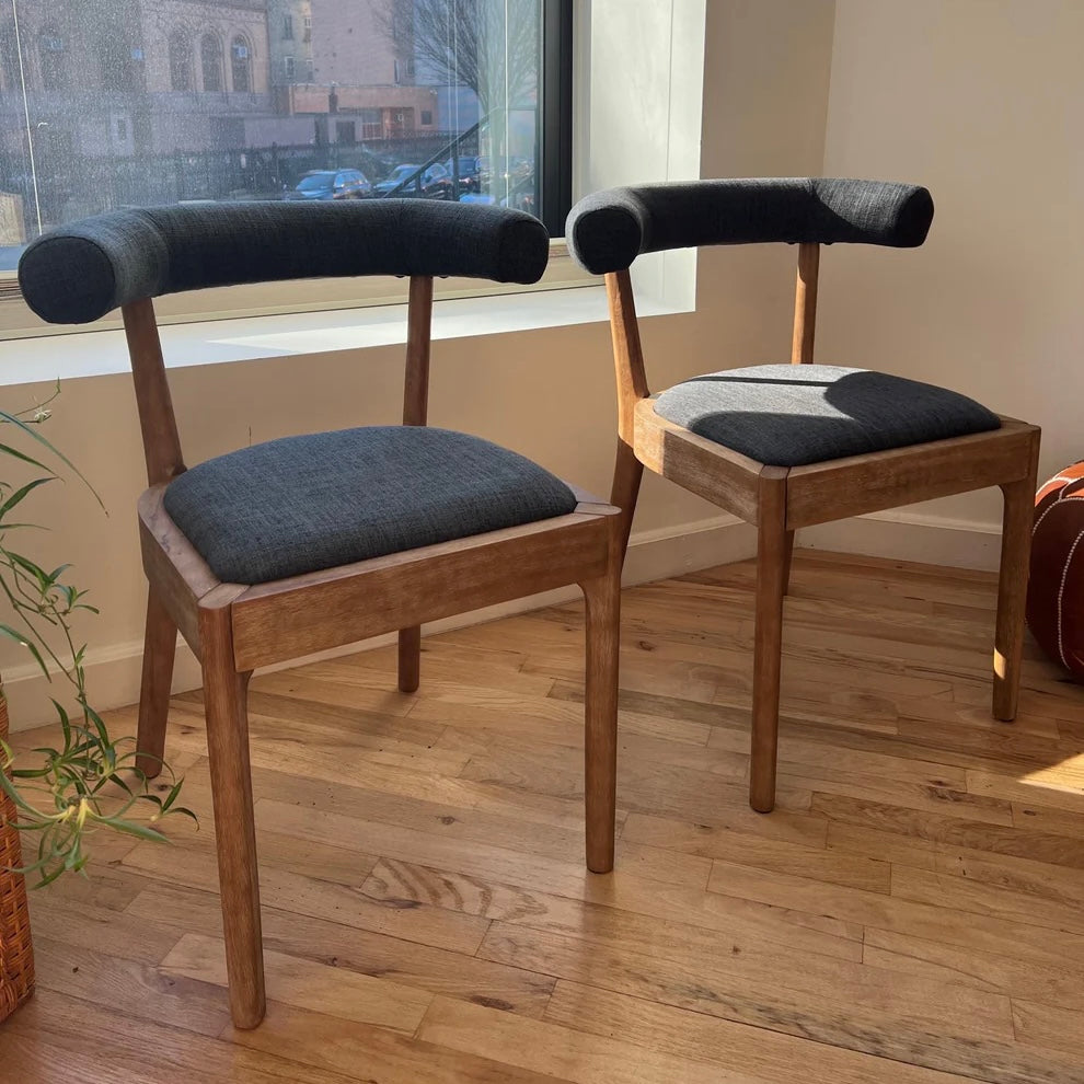 solid wood dining chairs with navy upholstery and ergonomic backrests suitable for a circular dining table