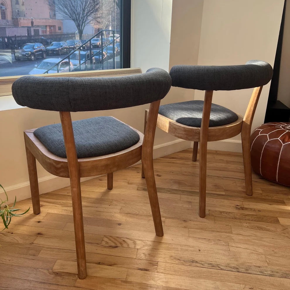full rearview of dining chairs with navy upholstery and solid wood legs and base