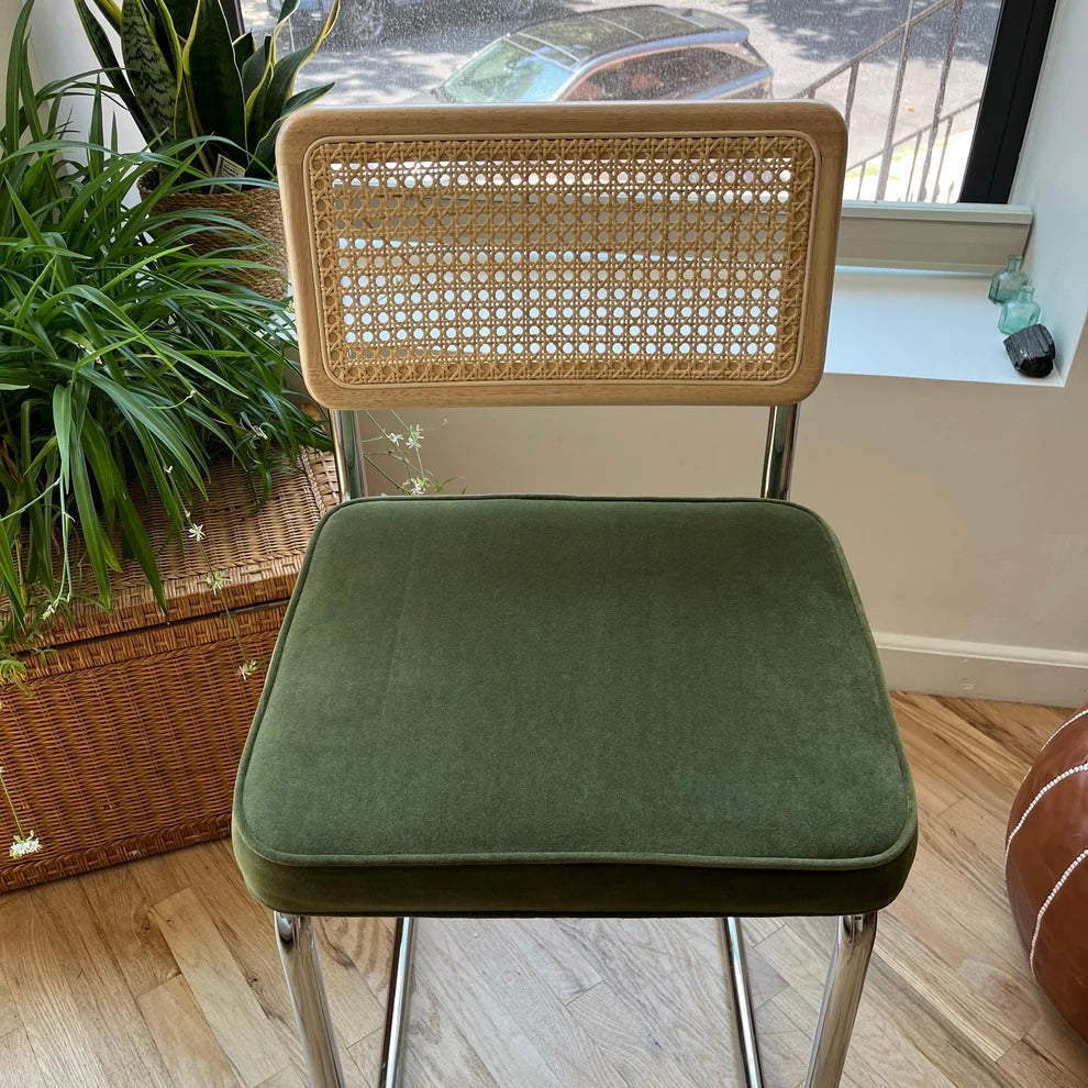 overview of a 26 inch seat hight counter stool with natural rattan back rest and green velvet seat