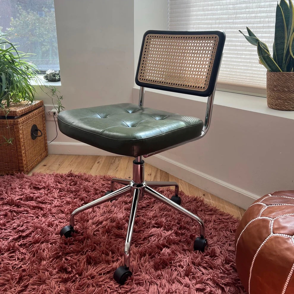 mcm office chair with green vegan leather seat and solid black wood back rest with rattan accents
