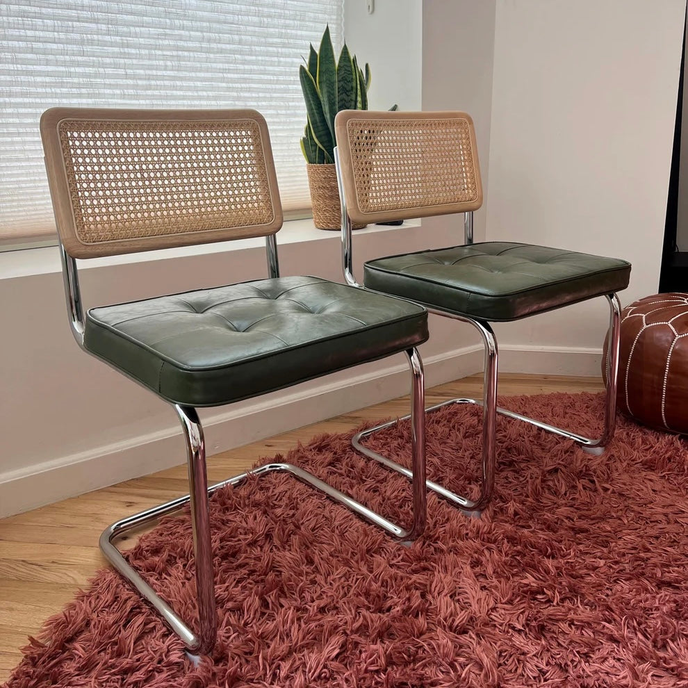 Green vegan leather dining chairs with solid wood and natural rattan backrests and stainless steel frames