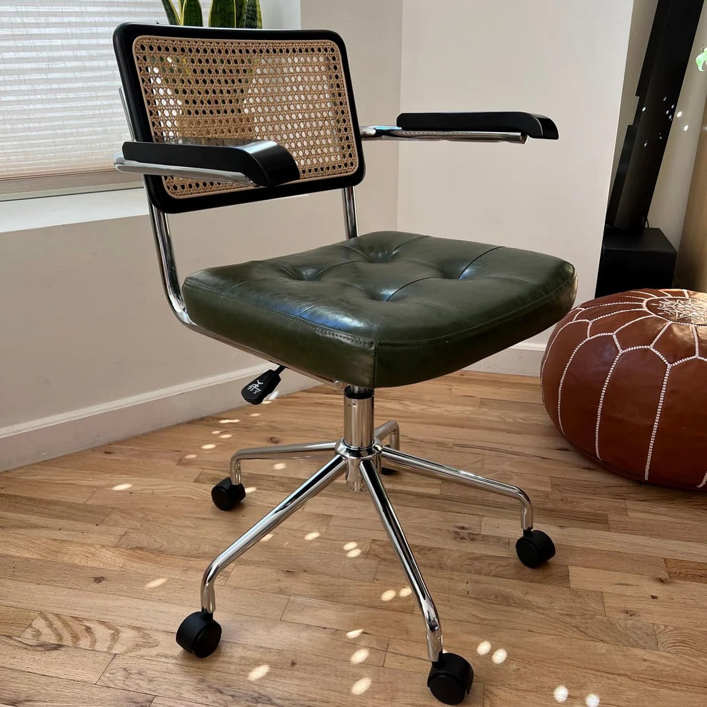 quarter side view of mcm office chair with green vegan leather seat stainless steel frame and black stained wood accents