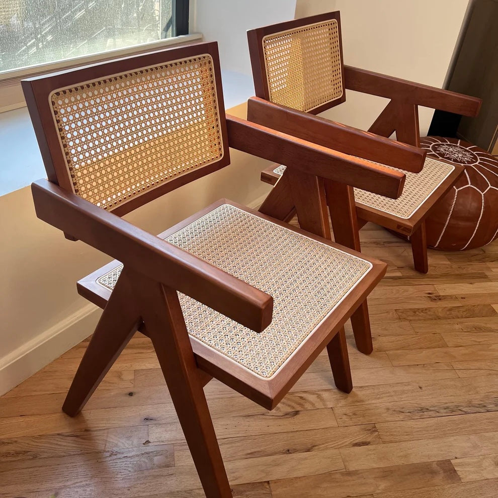 Side profile of walnut stain dining chairs with rattan seats and seatbacks in mid century modern style