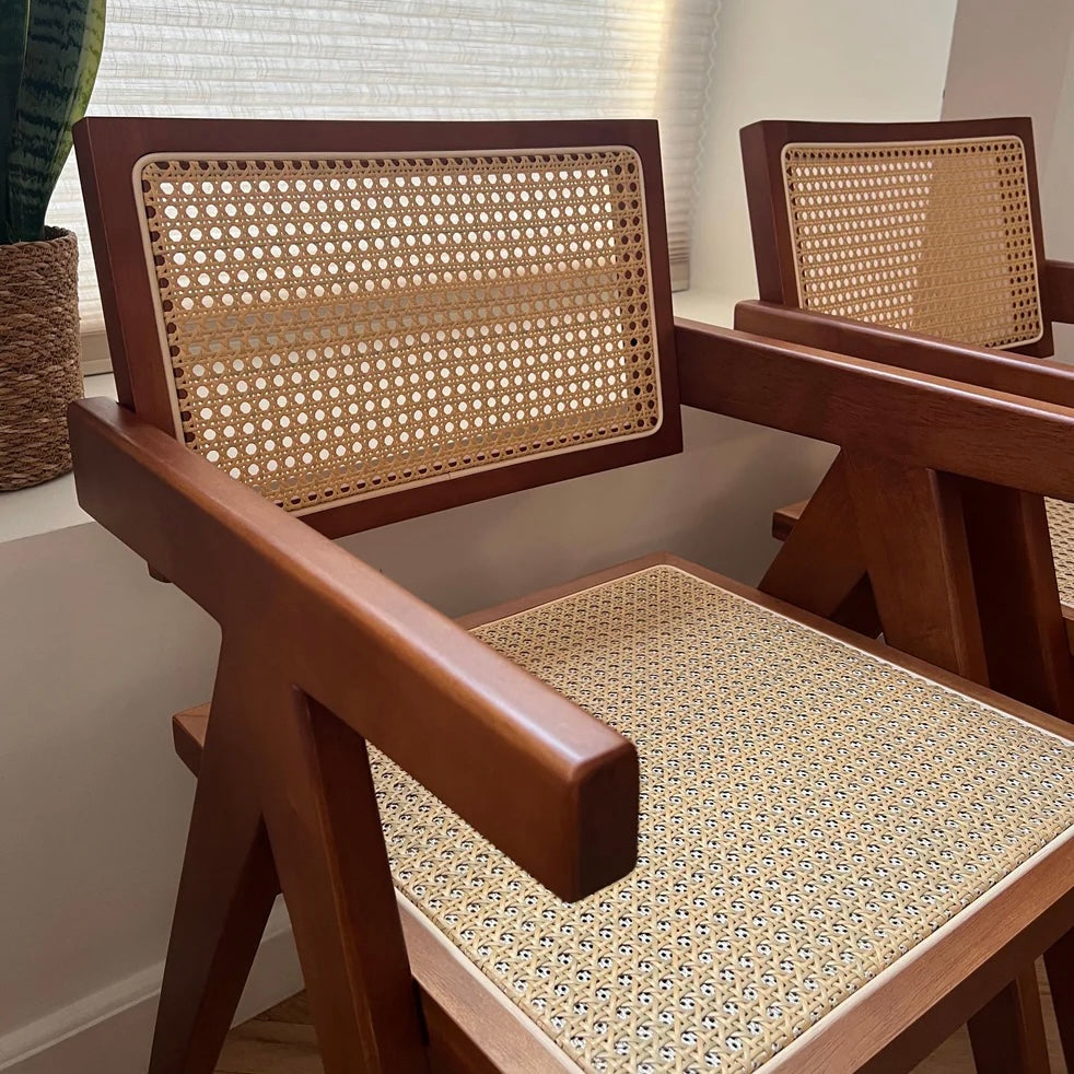 Close up quarter side view of walnut stain rattan seat dining chairs