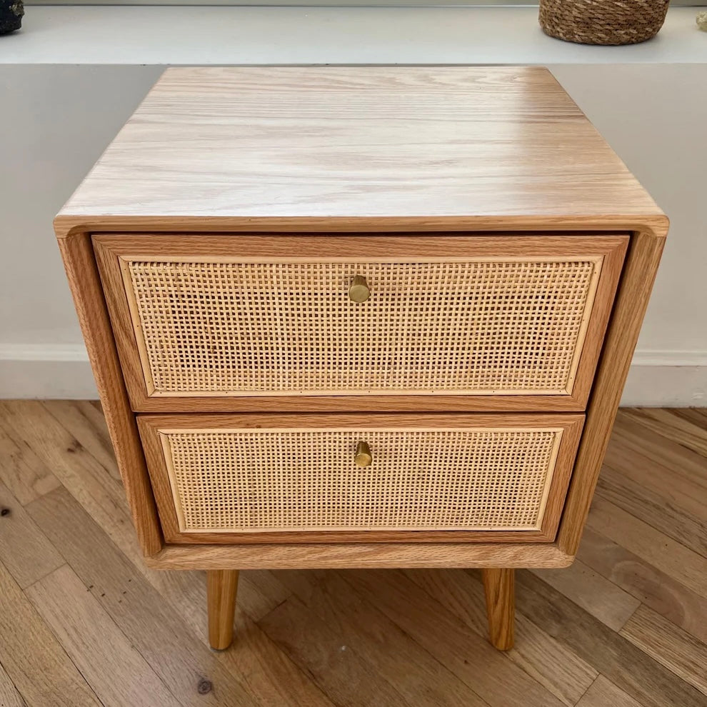 Overview of nightstand with bedside table drawers closed showing rattan accents on the front of drawers
