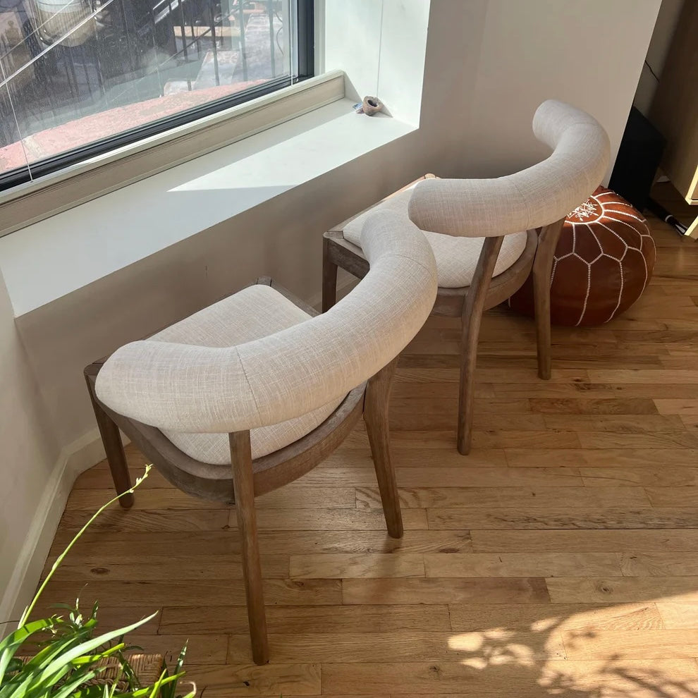 overview of solid wood dining chairs with beige linen upholstery for circular dining table