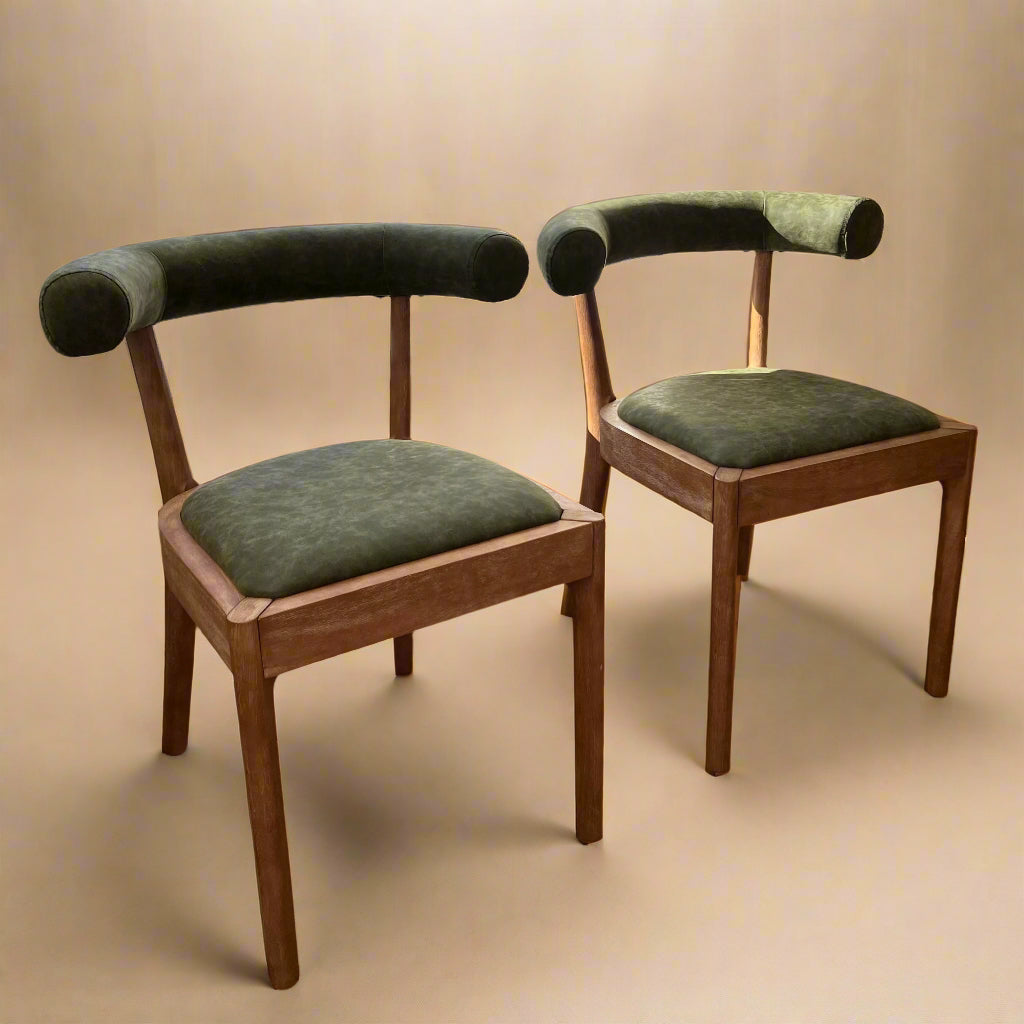 Solid wood dining chairs with green vegan leather seats and ergonomic backrests