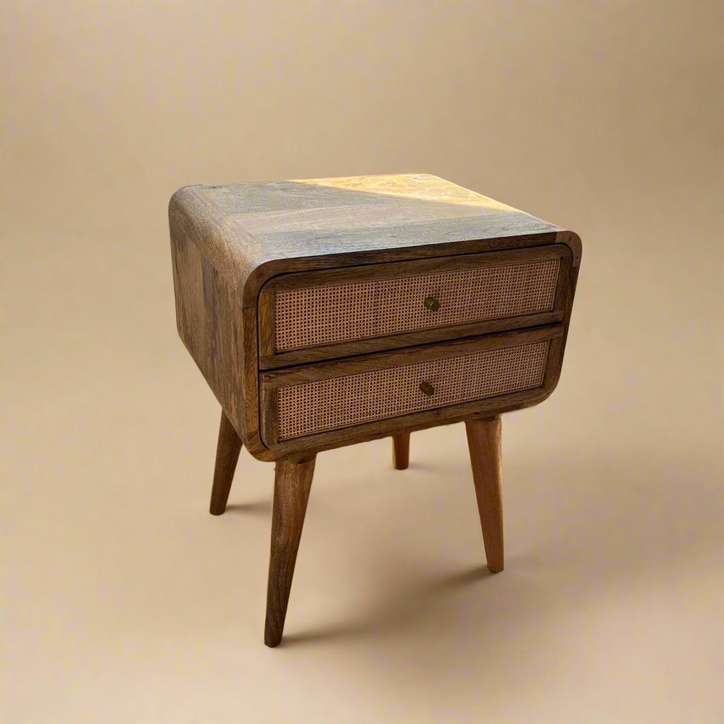 solid wood two drawer nightstand with rattan acccents and warm lighting