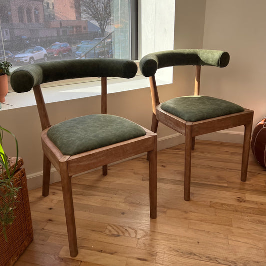 solid wood and green vegan leather dining chairs in a mcm designed room