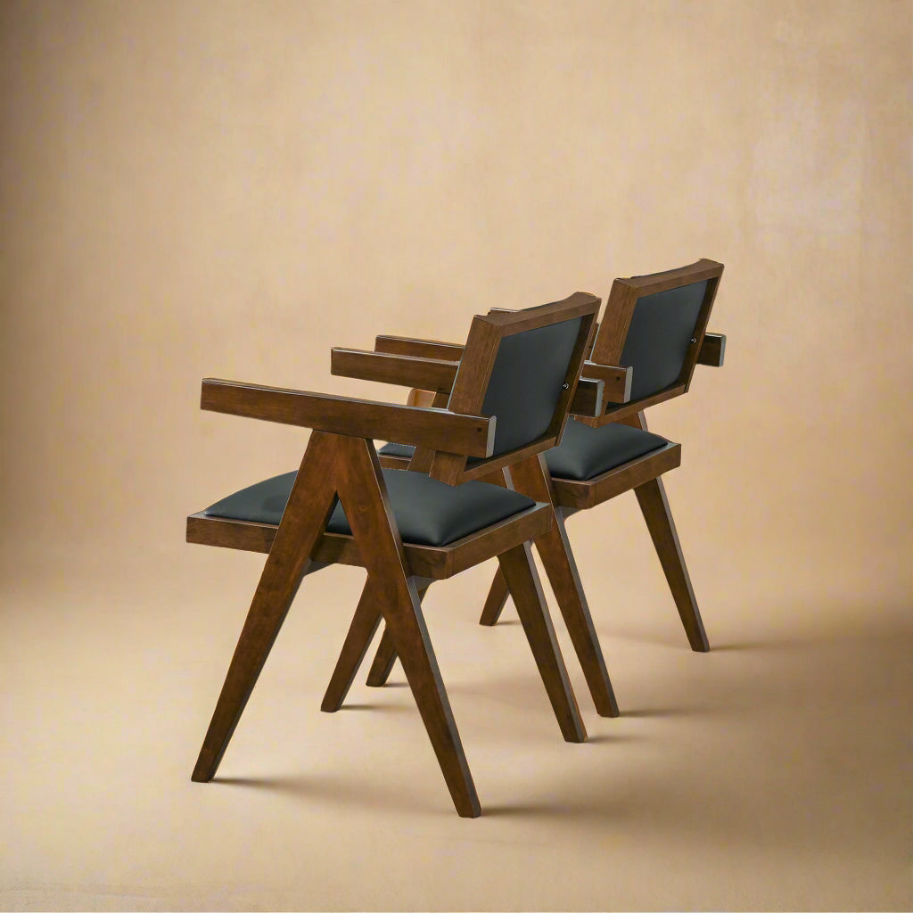 quarter shot of solid wood black vegan leather dining chairs showing the back made of leather