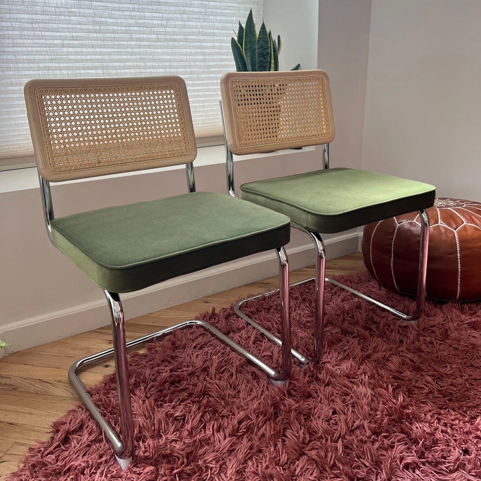 green velvet dining chairs with rattan and solid wood backrests and stainless steel frames