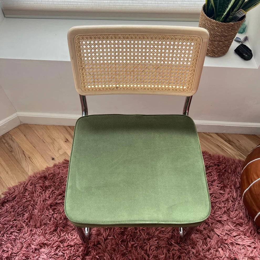 overview of mid century modern dining chair with solid wood back stainless steel frame and green velvet upholstery