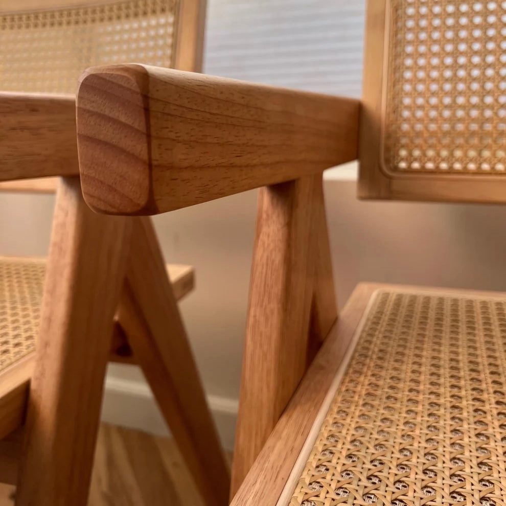 Natural wood pattern on beautiful dining chair with rattan accents visible