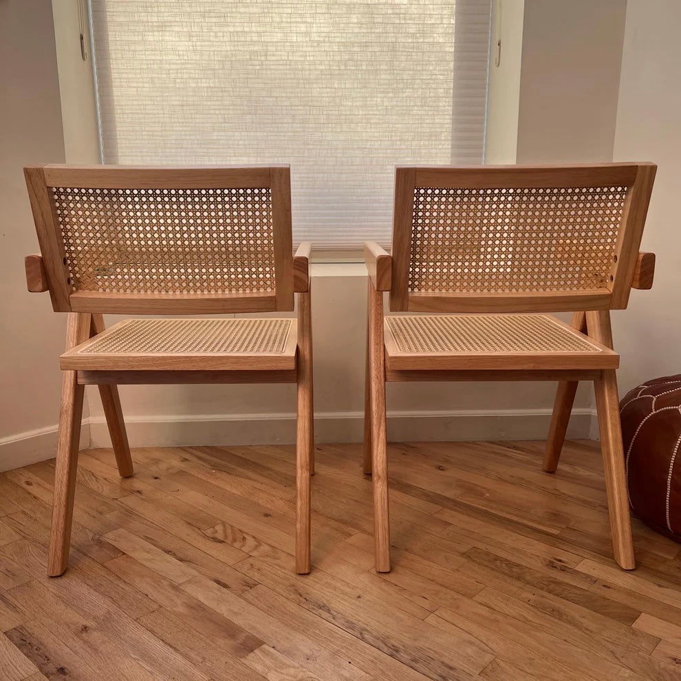 Rearview of natural hardwood dining chairs with rattan accents in mid century modern style