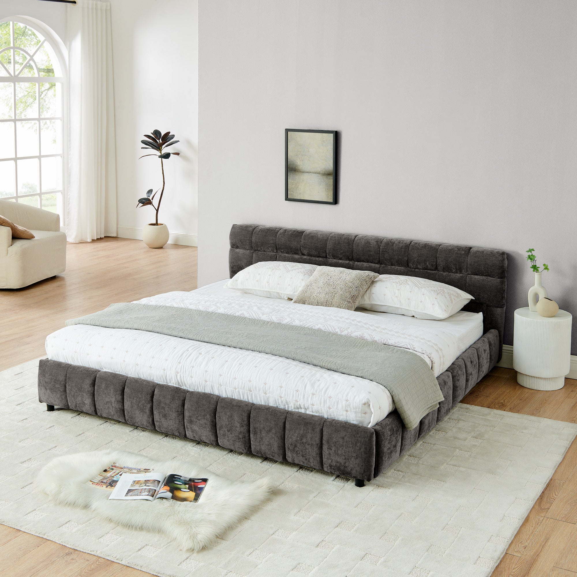 Dark gray king bed frame with two storage drawers open, one holding a pillow