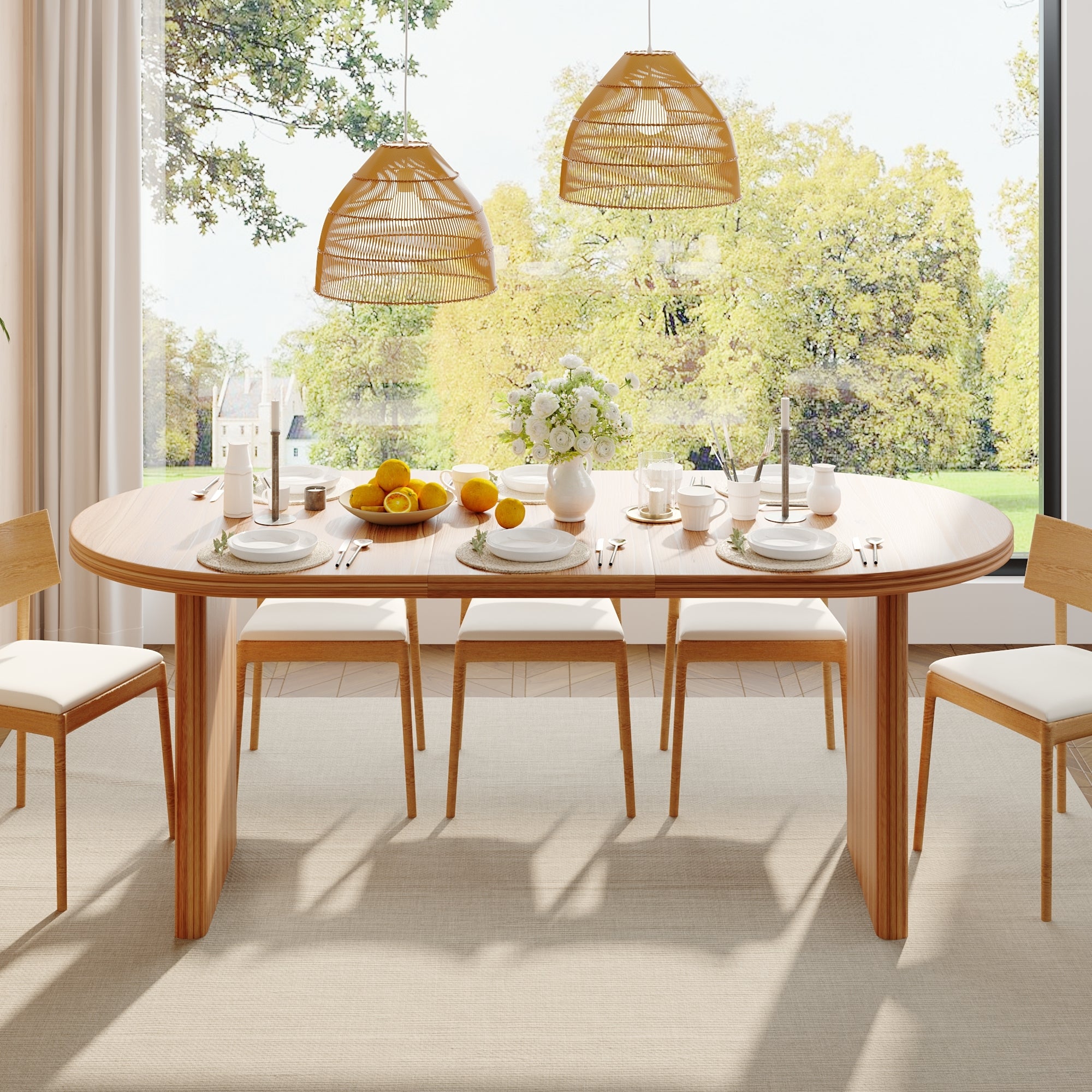 Front view of the extendable oval dining table fully set with chairs by a large window