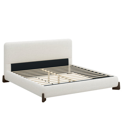 White bouclé king bed frame with dark wood sled legs on white background