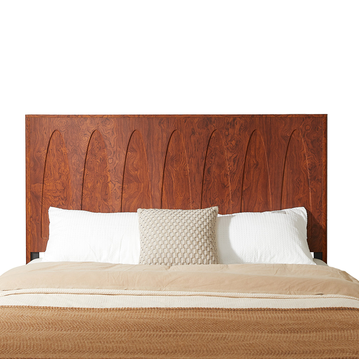 Front close-up of arched groove dark reddish-brown wood headboard with pillows, on white