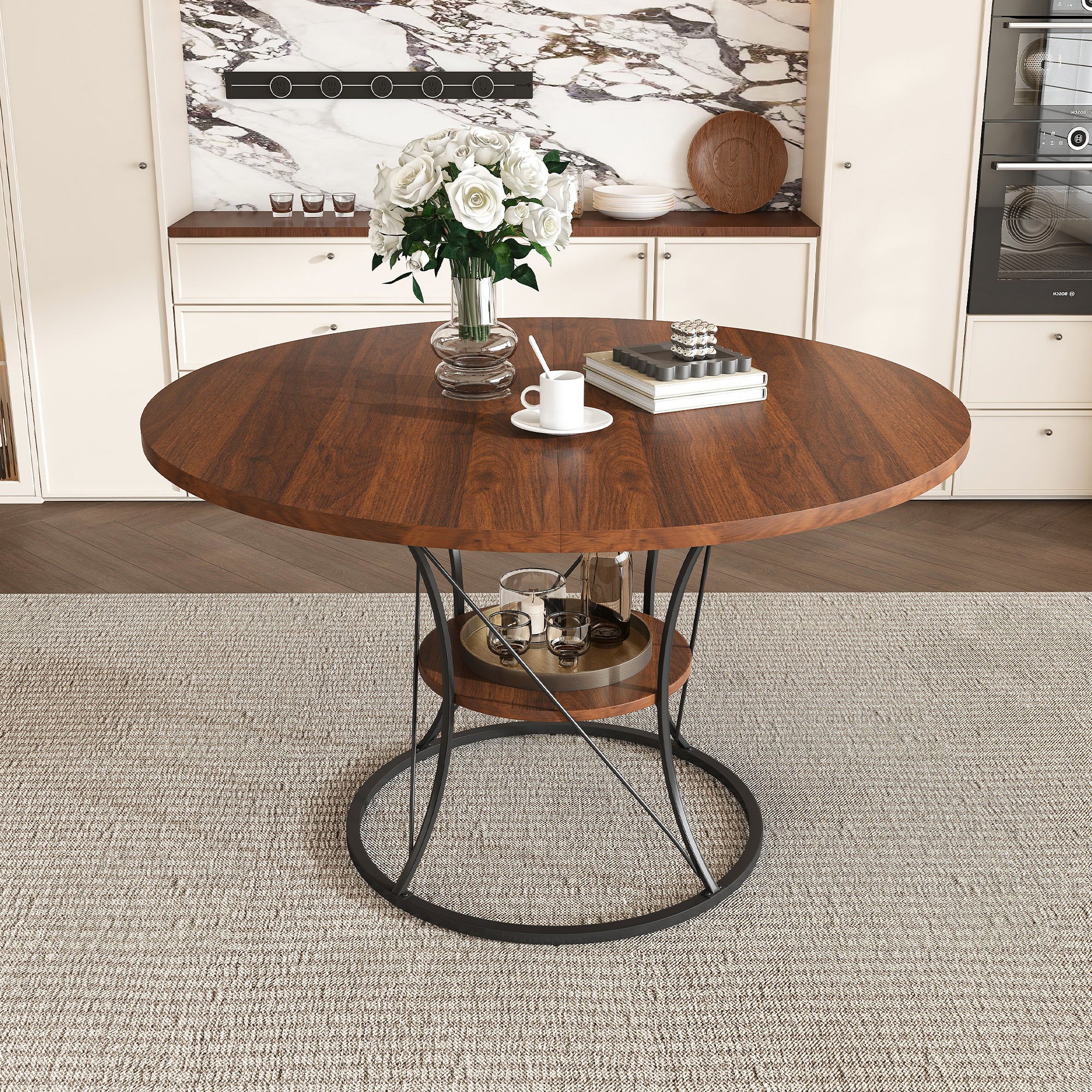 Walnut round dining table with a black iron base in a bright kitchen, front view
