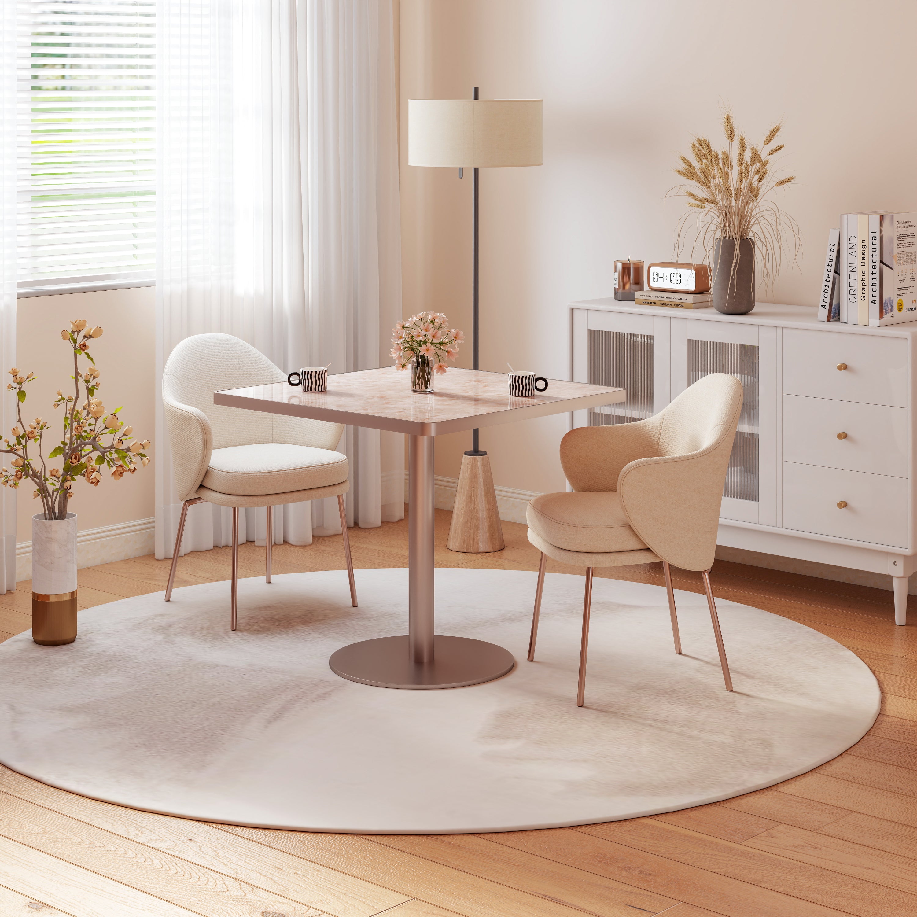 Pink stone square dining table in warm styled room with cream chairs and floor lamp