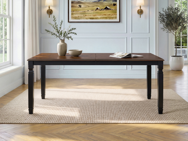 Espresso oak veneer farmhouse dining table, front view in a styled room with sconces and framed art