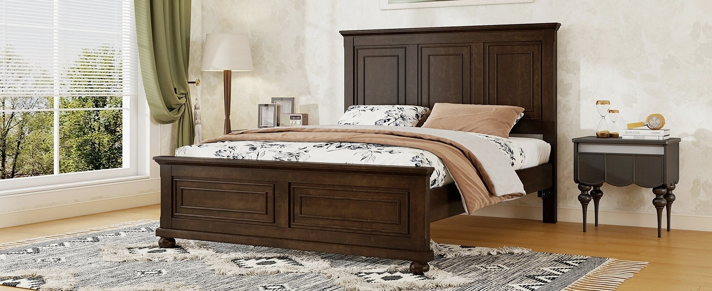 Angled view of the brown queen bed from the foot with a single nightstand and floor lamp by a window