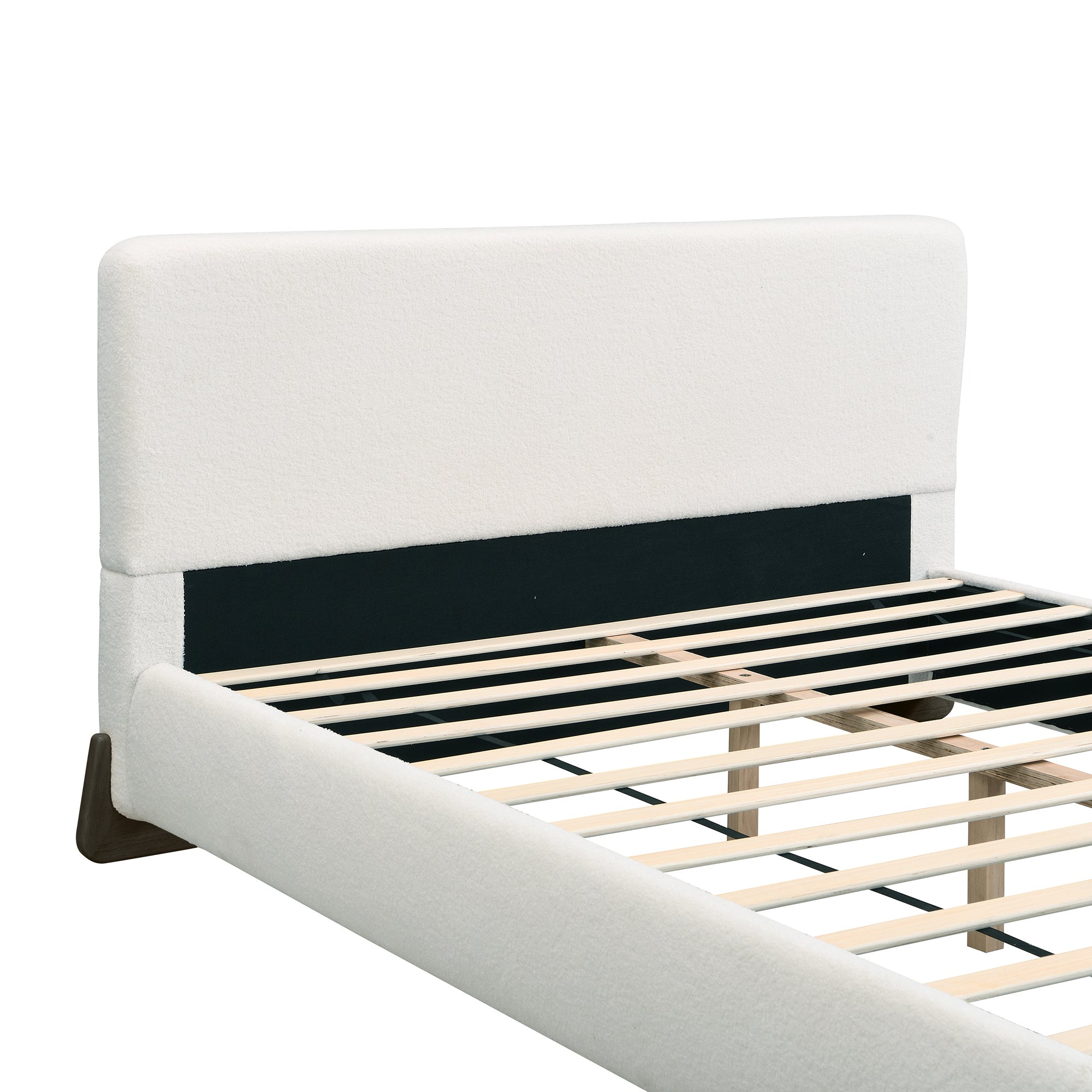 Close-up of white bouclé headboard corner with black interior support panel
