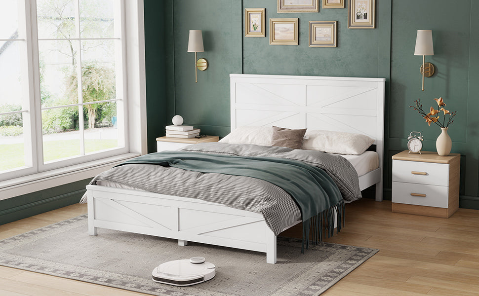 Wide angled bedroom view of the white barn door queen bed on a patterned rug with a robot vacuum