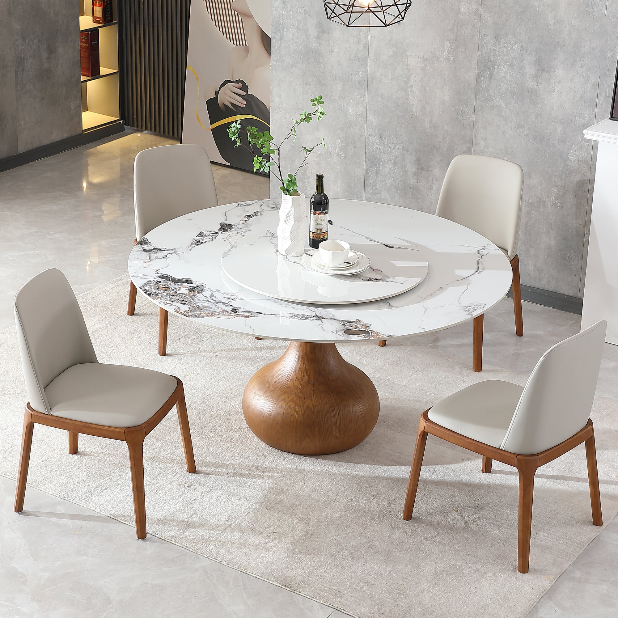 White sintered stone dining table with turntable and four chairs in a styled dining room, overhead view