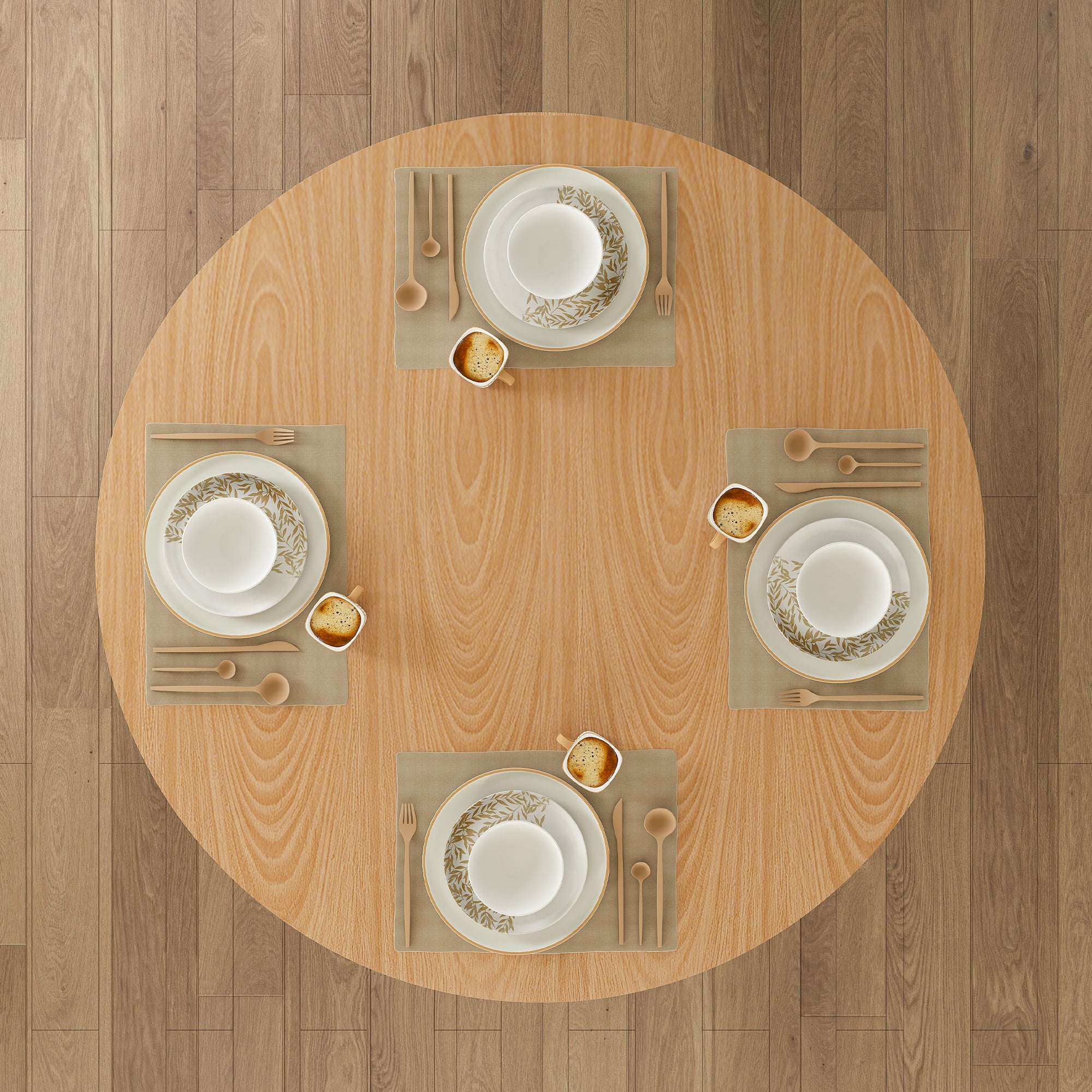 Overhead view of oak round dining table set for four with placemats, plates, and coffee on a wood floor