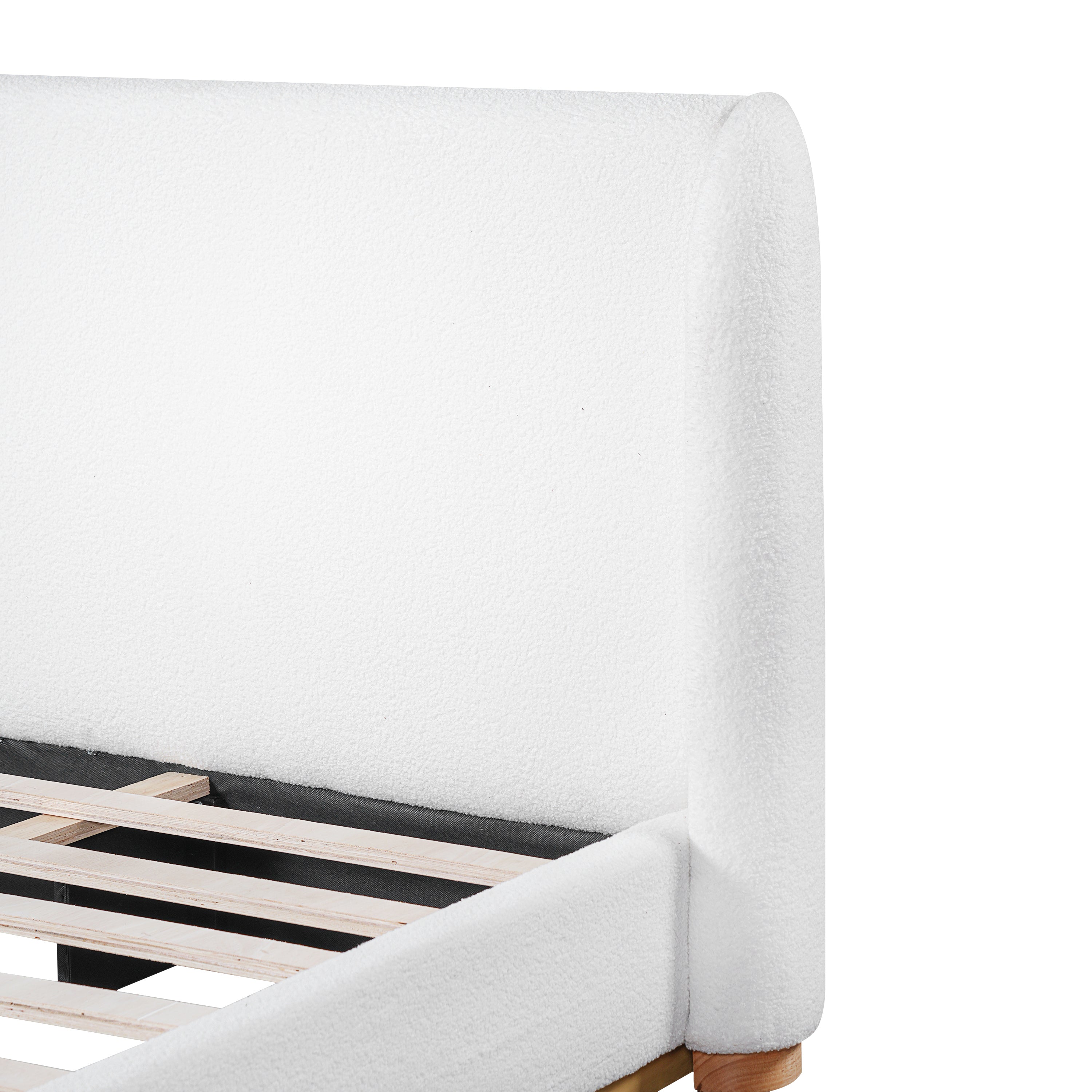Close-up of rounded white bouclé headboard corner on king bed frame