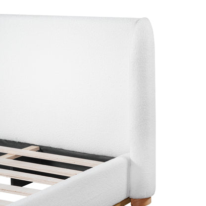 Close-up of rounded white bouclé headboard corner on king bed frame